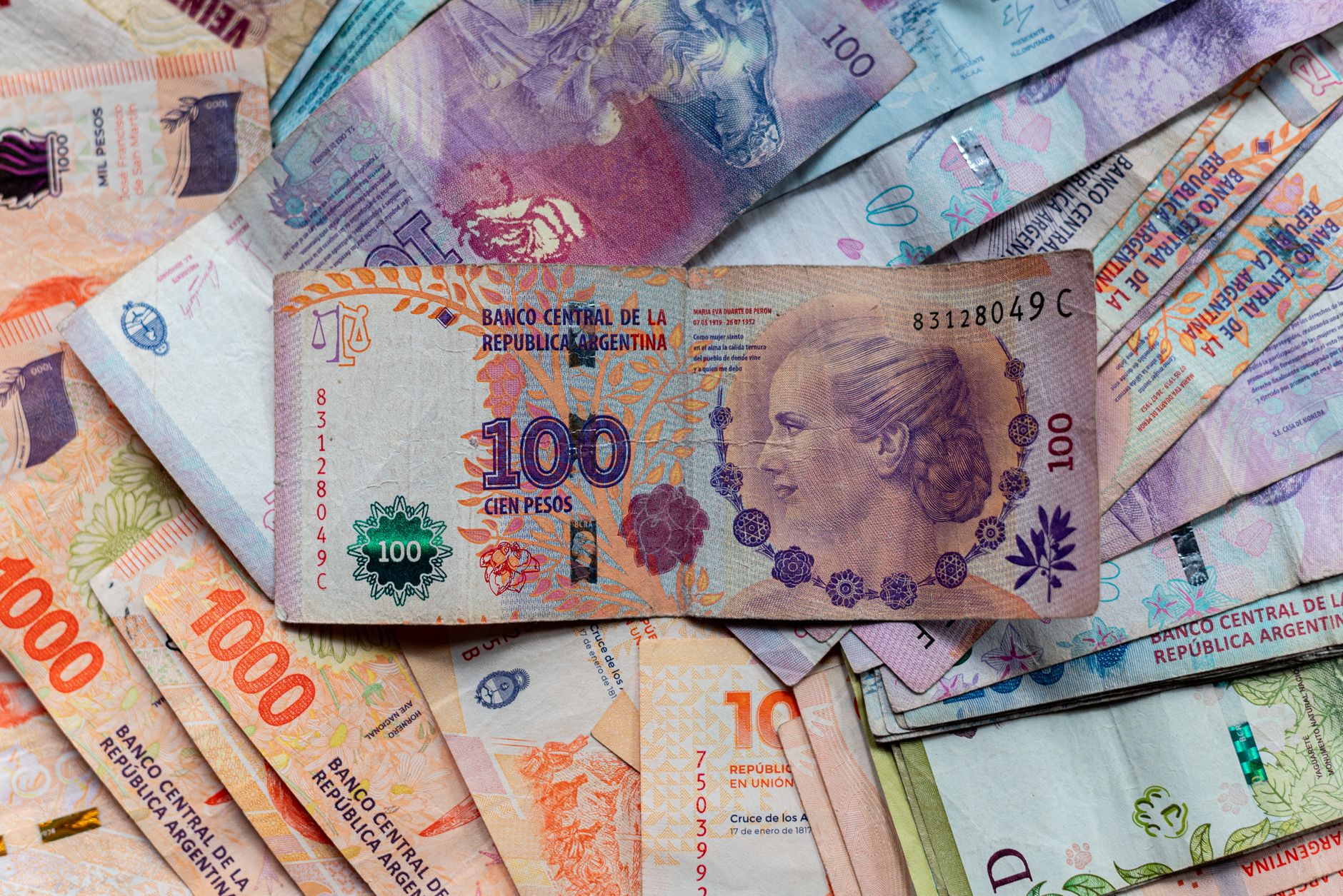 A collection of colorful Argentinian peso bills, featuring diverse denominations and designs. — Canadian Franchisee Loans and