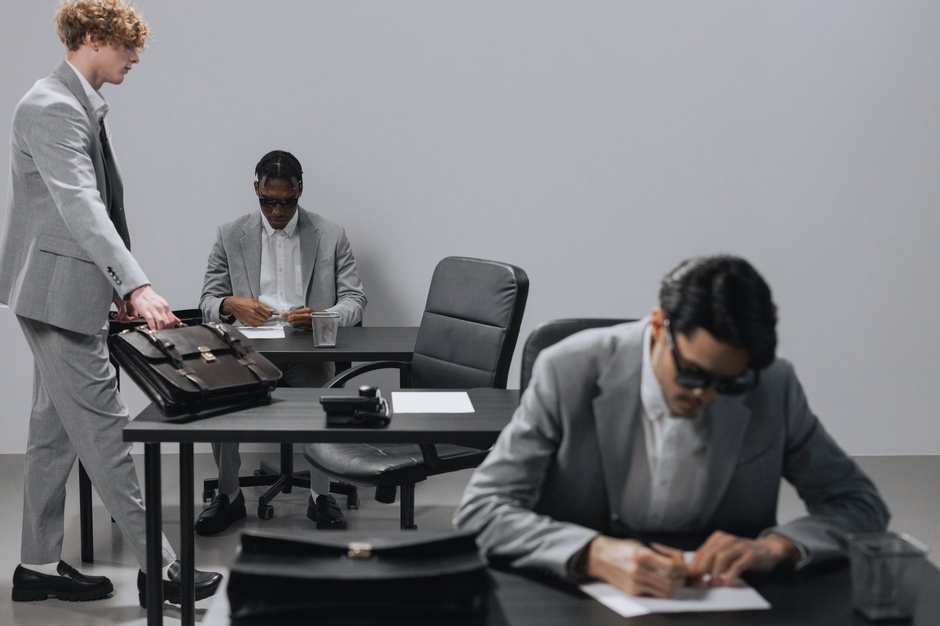 Business office with diverse employees in gray suits working at desks in an indoor setting. — Custom Printing Solutions for Y