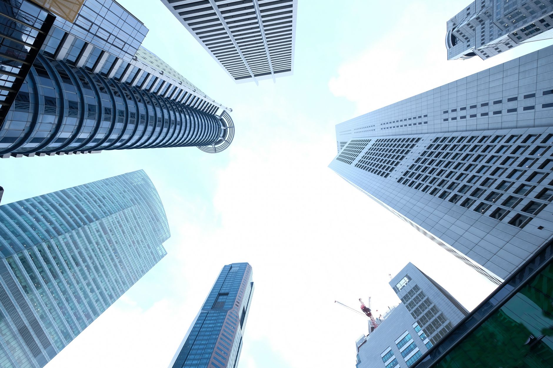 A striking upward view of various skyscrapers in an urban setting against a clear sky. — How can I get justice for personal i