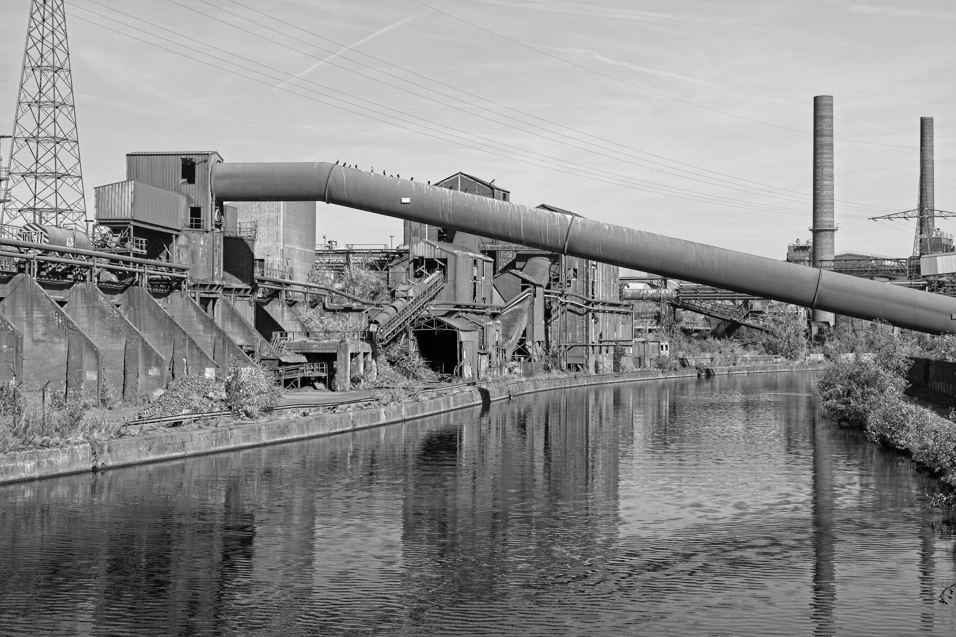 Black and white photo of an industrial scene with chimneys in Charleroi, Belgium. — Industrial Wireless: Improving Performanc