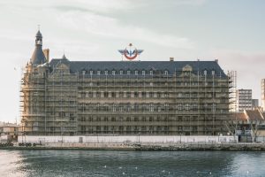 Scaffolding on a historic waterfront building under renovation. — Is the 82 Lottery App Safe and Legal in India?