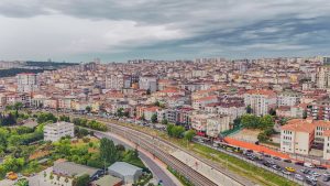 Aerial view of dense urban architecture with roads and greenery under cloudy skies. — Is the TC Lottery App Safe and Legal in