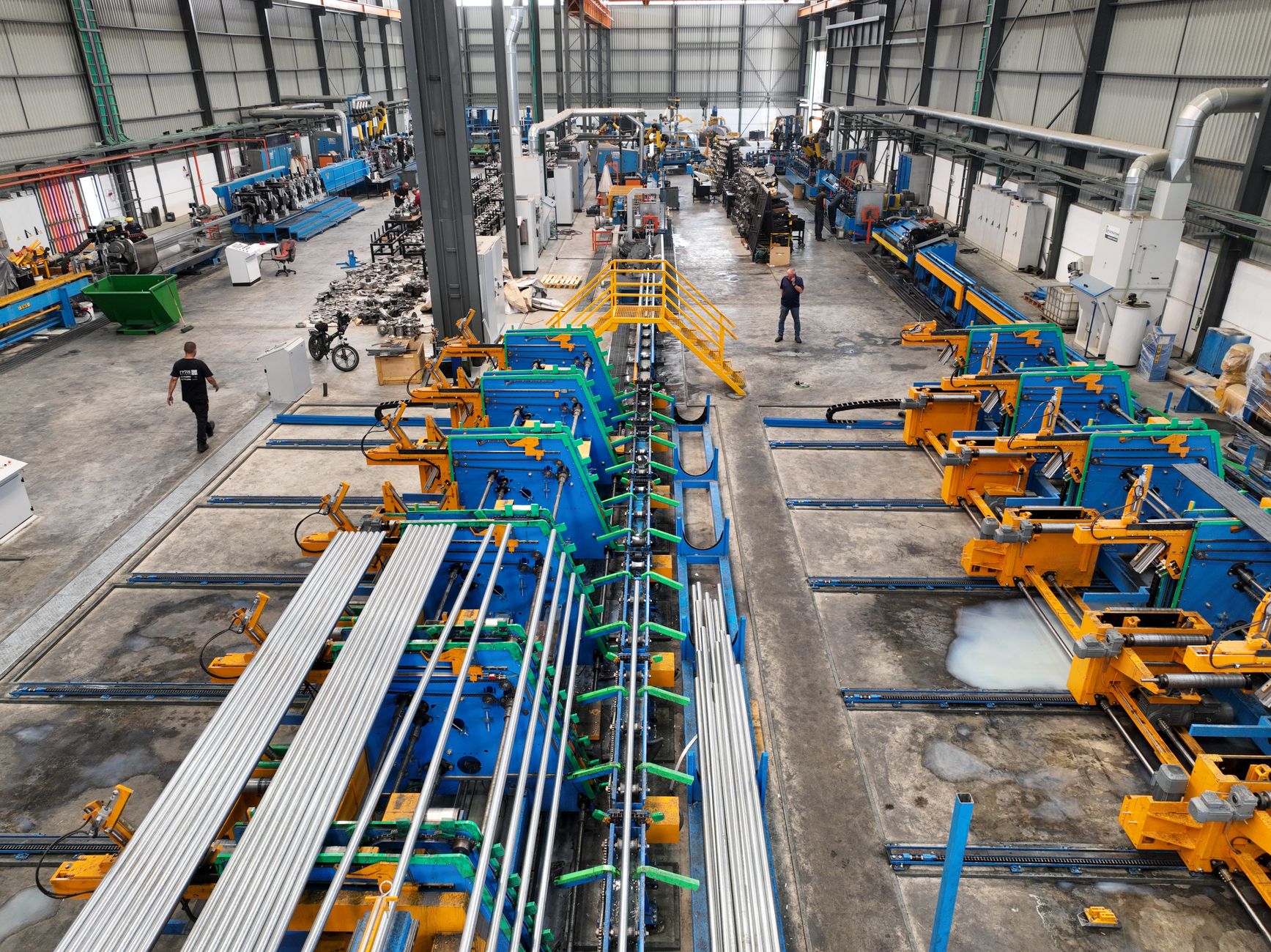 Aerial view of a large manufacturing plant interior with machinery and workers. — Landing Music Business Jobs or perhaps a Re
