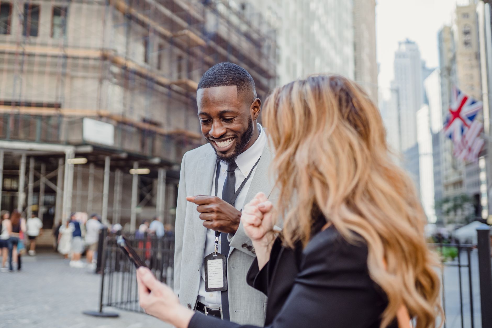 Two business professionals engage in lively conversation on an urban street, sharing insights. — Sell your home on the top cl