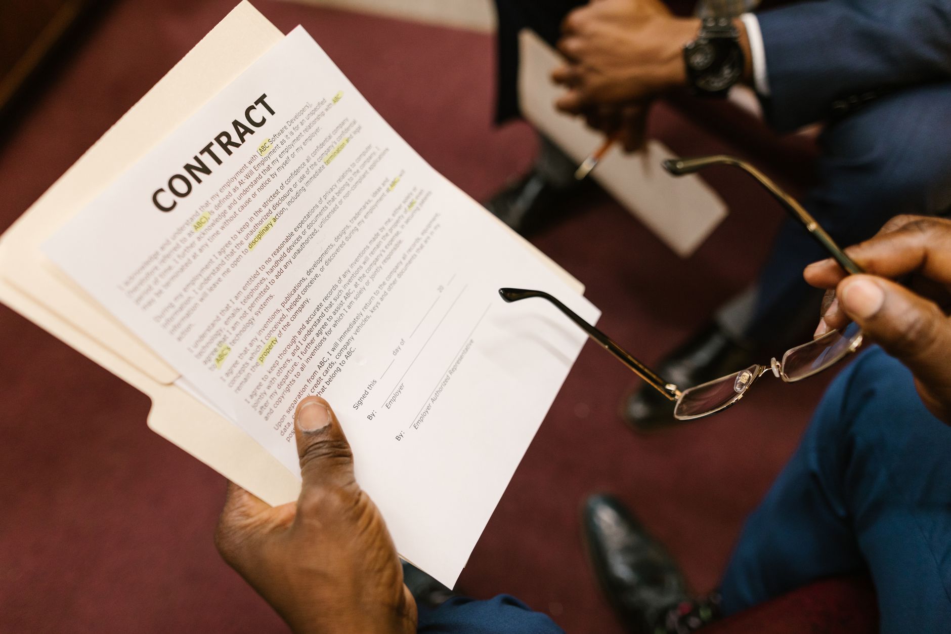Close-up of hands holding a contract, focus on business agreement discussion. — The Key from the Forgotten Laws and regulatio