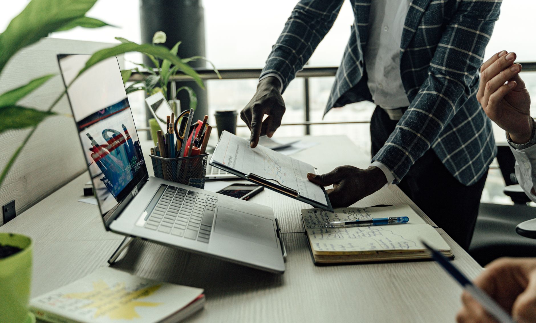 Colleagues collaborating on financial data analysis with a laptop in the office. — Things that you must know about a cryptocu