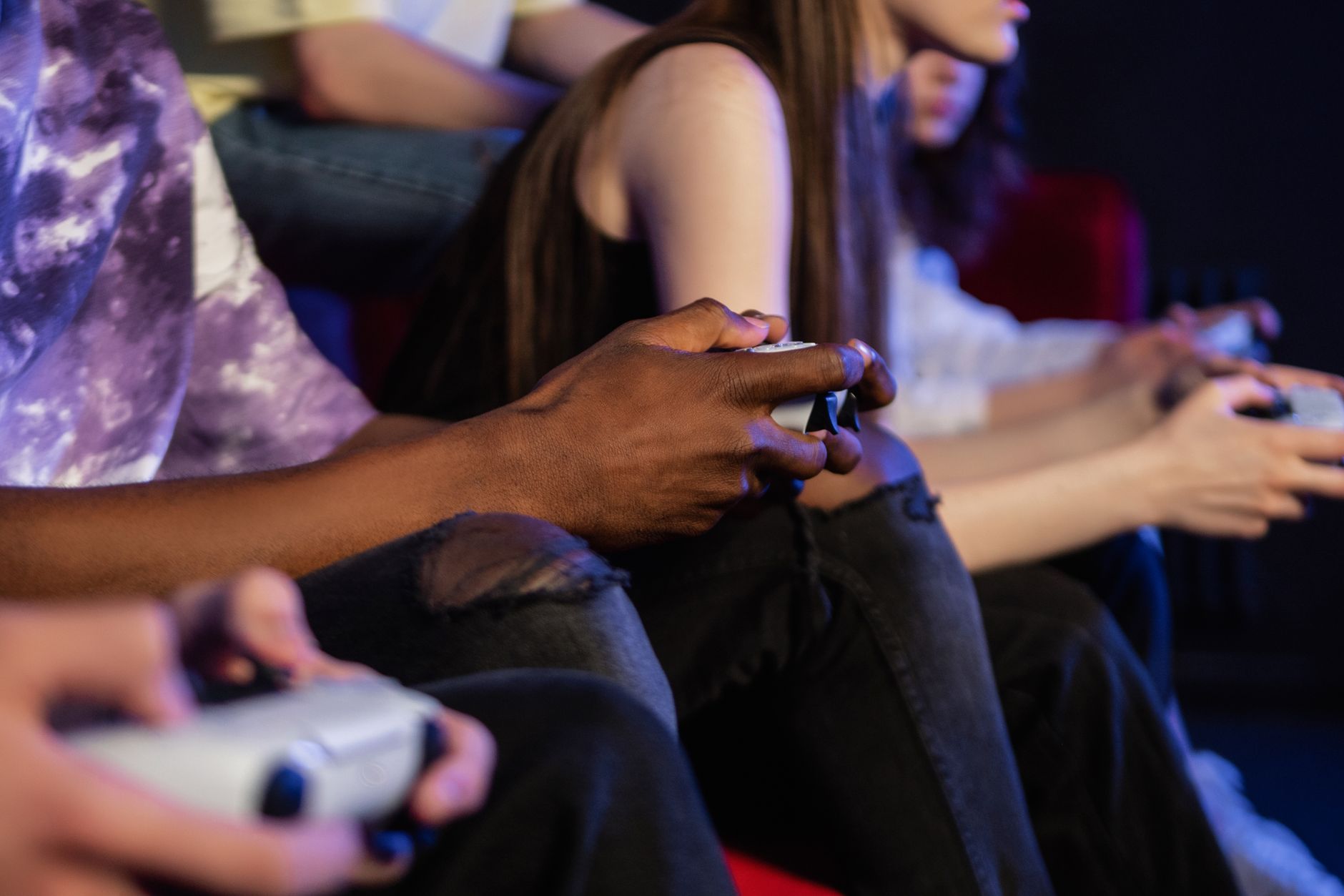 Teens playing video games with controllers, focused and engaged. — UFA SLOT: Easy Breaks and Full Payouts Await