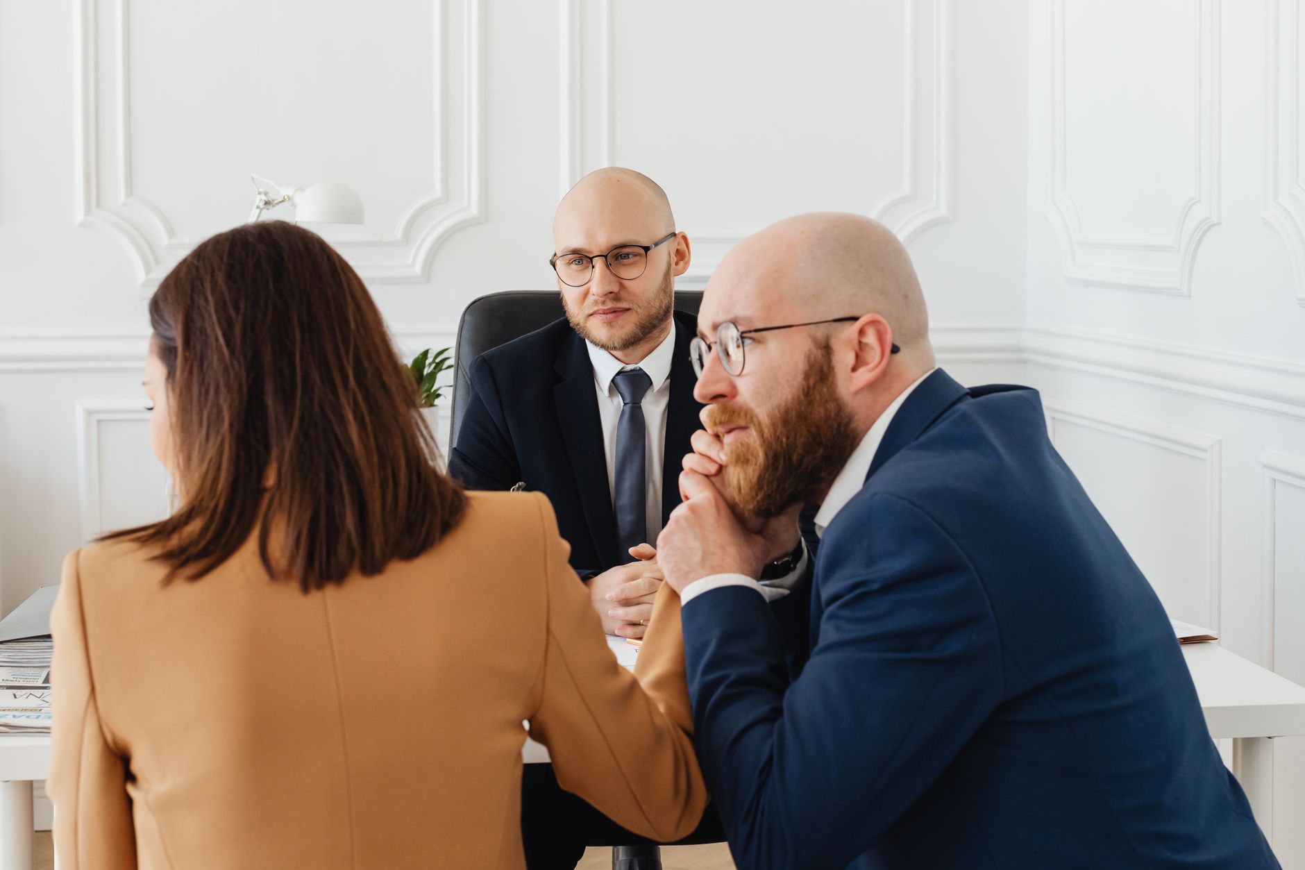 Lawyers consulting with clients in a modern office setting, discussing legal matters. — Understanding the obvious need for an